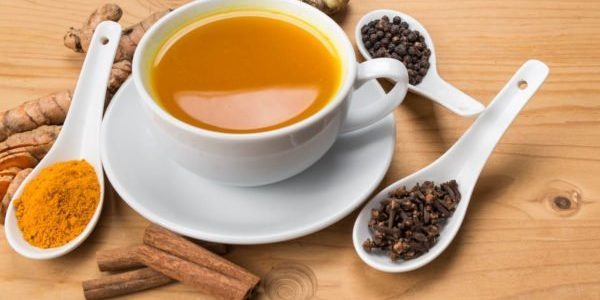 Aromatic turmeric tea with black pepper, cinnamon, cloves and ginger offers many wellness health benefits